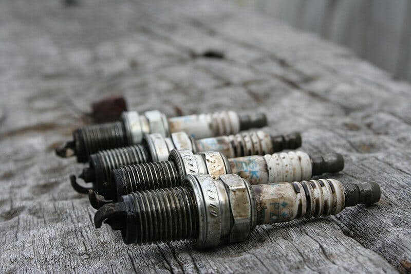 How do the properties of the spark plug affect engine parameters?